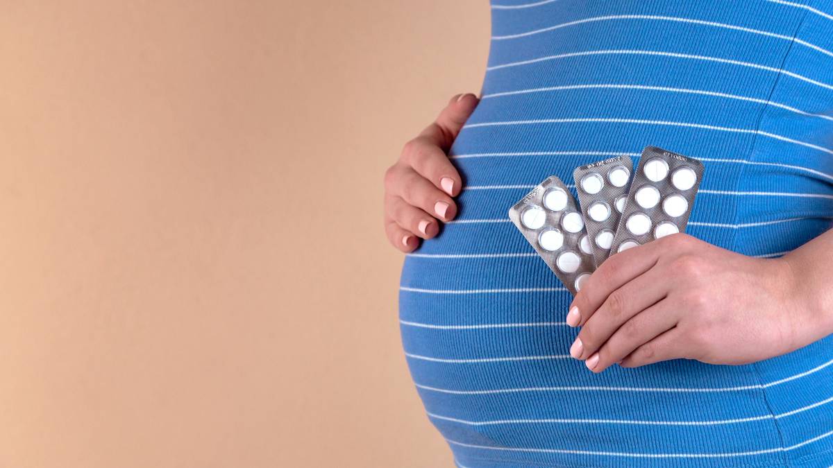 Woman reviewing prenatal vitamin safe dose with healthcare provider