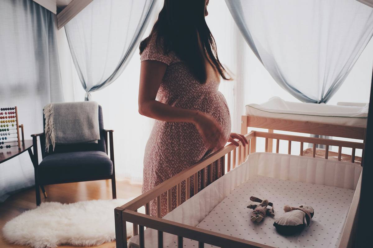 Bottle of seeking health prenatal vitamins next to fresh fruits and omega-3 sources like salmon and walnuts